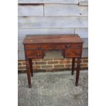 An early Victorian mahogany "lowboy" with lift up lid, fitted interior over two faux drawers and two