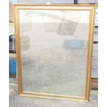 A bevelled edge wall mirror, in gilt and silvered frame, plate 41 1/2" x 54 1/2" wide, and a