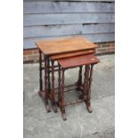 A nest of three mahogany occasional tables, on turned and stretchered supports, largest 22" wide x