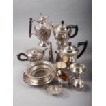 A silver plated three-piece teaset, a plated hot water jug, a plated on copper bottle coaster and