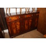 A mahogany sideboard of Georgian design, fitted three drawers over three cupboards, on bracket