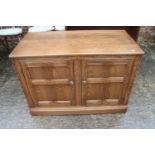 An Ercol side cupboard enclosed two doors, on block base, 39" wide x 19" deep x 27" high