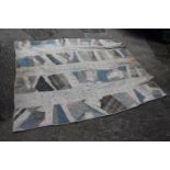 An early 20th century patchwork quilt, in shades of blue, pink and cream, 72 1/2" x 62" (torn and