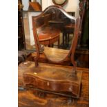 A figured mahogany and rosewood banded swing frame shield-shaped toilet mirror, on plateau base,