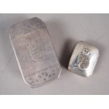 A silver octagonal snuff box with engraved decoration and a white metal pill box with applied cat