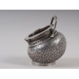 An Oriental silver heavily chased, engraved and parcel gilt sugar bowl with later import marks, 4.