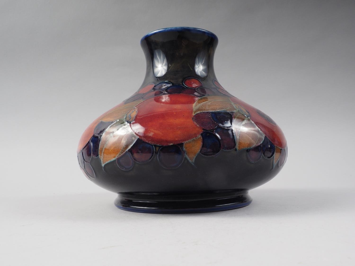 A Moorcroft pomegranate bulbous vase, 6 1/2" high (crack to rim)