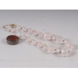 A rose quartz faceted bead necklace and a white metal pill box, stamped 900, inset Arabic script