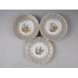 A set of twelve 19th century Meissen figure pierced decorated gilt scrollwork dessert plates (two