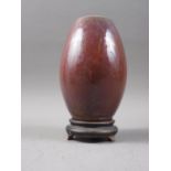 A Chinese flambe glazed barrel-shaped vase, 6 1/2" high, on turned hardwood stand