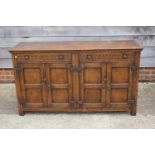 A dark oak sideboard of 17th century design, fitted two drawers over cupboards enclosed panelled