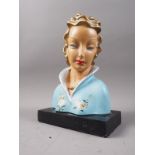 A Lenci style Art Deco bust of a woman in floral coat, on black plinth base, 10" high