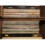 A quantity of mostly 33rpm records, including Eric Clapton "Backtrackin", The Eagles "Their Greatest