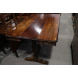 An early 20th century mahogany extending dining table with extra folding centre leaf and Wabash