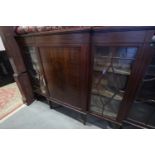 A 1930s breakfront display cabinet with centre panel door and two lattice glazed doors, on square