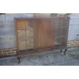 An Edwardian mahogany display cabinet enclosed panel door, flanked lattice glazed doors, on cabriole