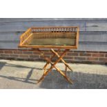 A butler's satin birch spindle galleried tray with brass base, on 'X' frame stand, 30" x 21 1/2"