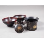 A Japanese lacquered stand, decorated arabesques, another Japanese lacquered stand and three
