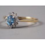 An 18ct gold aquamarine and diamond cluster ring, size P