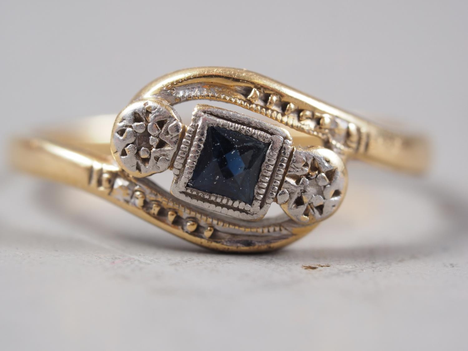 An 18ct gold, sapphire and diamond crossover ring, size J/K, 1.8g, and a 22ct gold wedding band, - Image 2 of 2