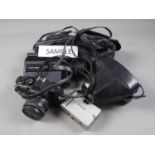 An Olympus OM10 camera, in case, a Petri GX-1 camera, a Canon 514XL camera, and other cameras and
