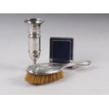 An embossed silver backed hair brush, a Mappin & Webb silver bud vase, on weighted base, 6 1/2"