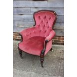 A Victorian mahogany showframe armchair, button upholstered in a pink Dralon, on turned supports