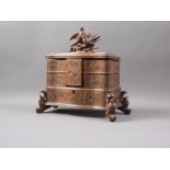 A carved Black Forest jewellery box, the lid carved with two birds and a nest with eggs
