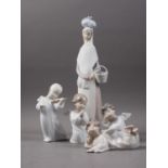 A Lladro figure, "Going to Market", 14" high, and four cherubs