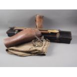 A pair of leather gaiters, a pair of khaki jodhpurs, a leather stirrup cup holder, a leather