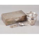 A silver cigarette box, a silver tea caddy, a silver caddy spoon with engraved decoration and a