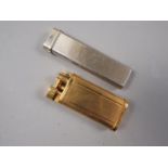 A Dunhill gold plated lighter, 2 1/2" long, and one other lighter