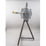 A WWII Carter Nelson air raid siren, on painted metal tripod stand