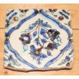 A 18th century Iznik tile, decorated floral spray, 5 1/2" square (some losses to borders)