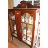An Edwardian mahogany and inlaid ledge back display cabinet enclosed two lattice glazed doors, 47"