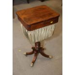 A William IV rosewood work table with fold-over top and well, on turned column and quadruple splay