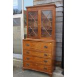 A 19th century walnut and burr yew inlaid secretaire bookcase, the upper section enclosed two