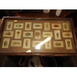 An early 20th century grained as walnut two-handled tray top, inset silk cigarette cards "Ceramic