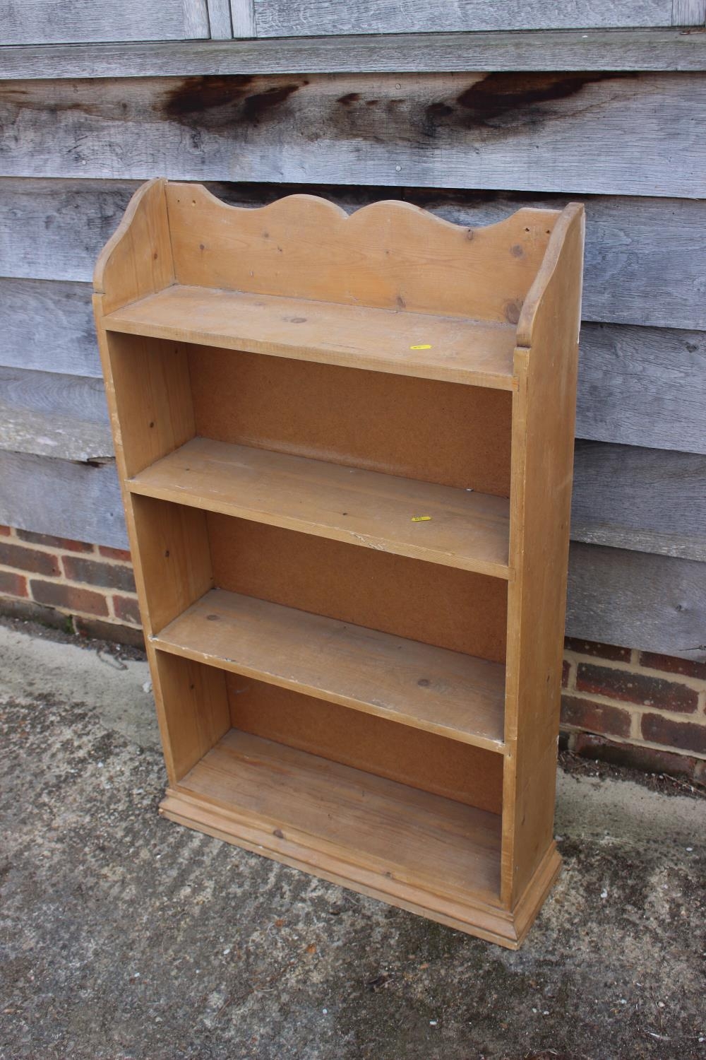 A pine bookcase, fitted four shelves, 26" wide x 7 1/2" deep x 41" high