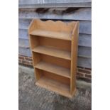 A pine bookcase, fitted four shelves, 26" wide x 7 1/2" deep x 41" high