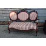 A 19th century carved rosewood showframe three-seat settee with cameo back and stuffed over seat,