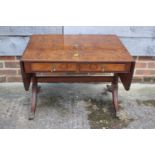 A figured walnut flap top coffee table, fitted two drawers, on shaped supports, 27" wide x 19"
