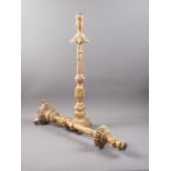 A pair of antique carved giltwood candlesticks, on circular bases with lion paw feet, 22" high (