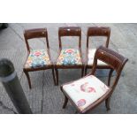 A set of four early 19th century mahogany reeded top rail standard dining chairs with