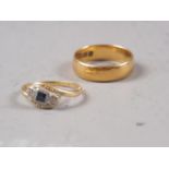 An 18ct gold, sapphire and diamond crossover ring, size J/K, 1.8g, and a 22ct gold wedding band,
