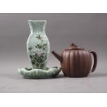 A Chinese Yixing pottery teapot with Dog of Fo finial (chip to spout), a celadon glazed dish,