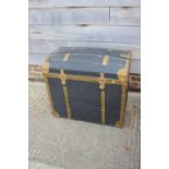 A brass bound dome top trunk with wrought iron carry handles, 30" wide x 18" deep x 26 1/2" high