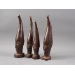 A set of four mid 20th century carved wenge "Benin" heads, tallest 9" high