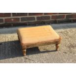 A 19th century carved giltwood stool, on turned faceted supports, 16" wide x 12 1/2" deep x 60 1/
