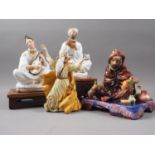 A Royal Doulton figure, "The Potter" HN1495, 7" high, a pair of bottles, formed as figures playing
